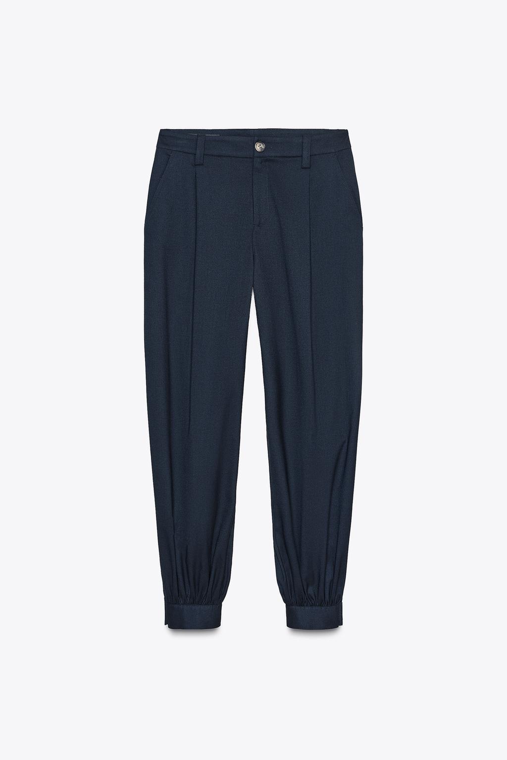 PANTALON À PINCES BAS BOUTON