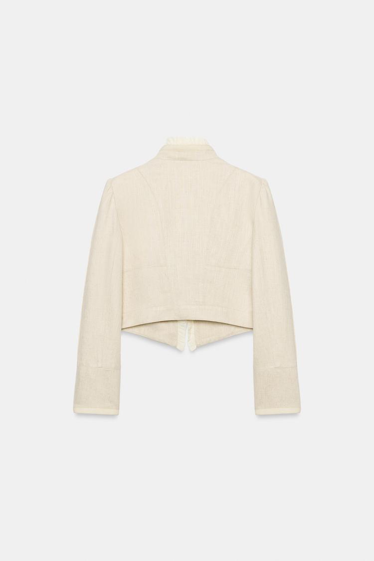 VESTE COURTE À VOLANTS