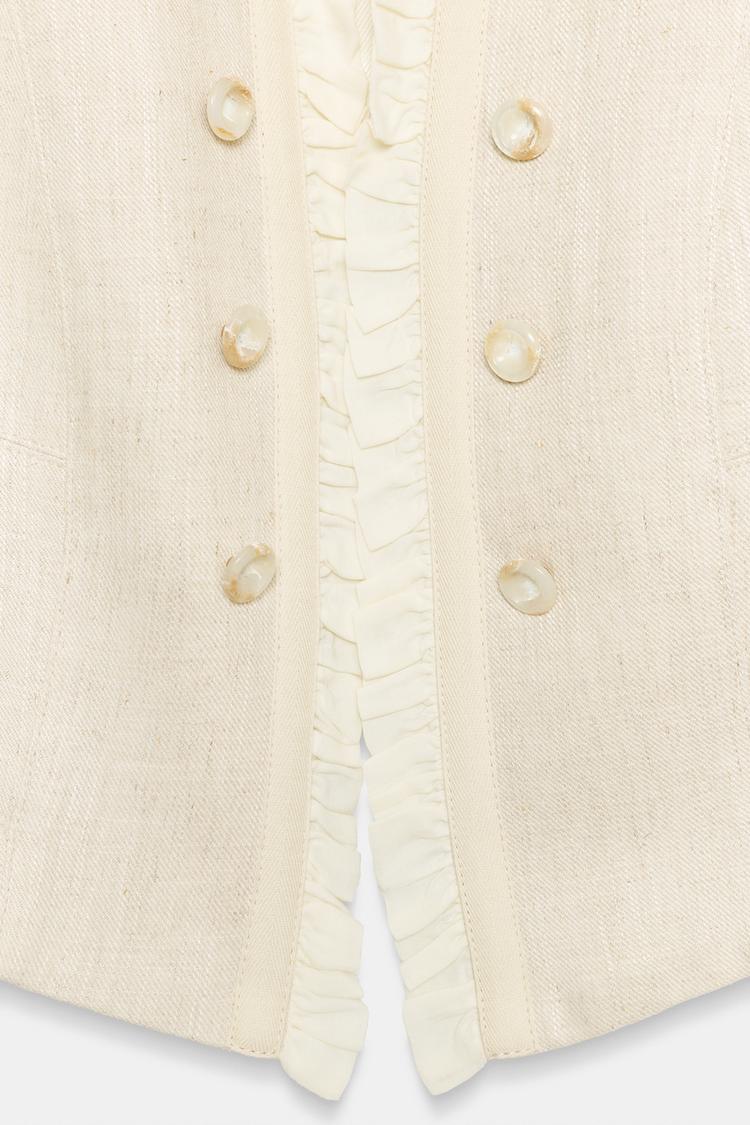 VESTE COURTE À VOLANTS