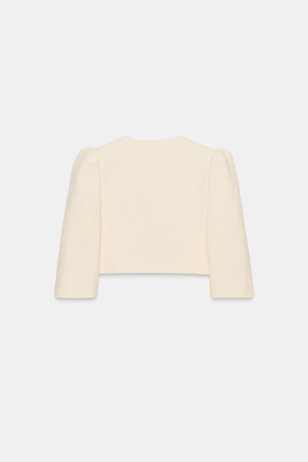 VESTE COURTE À MANCHES BOUFFANTES