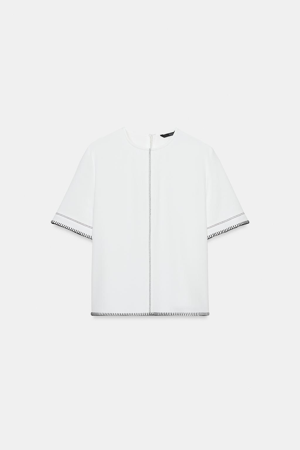 TOP À SURPIQÛRES CONTRASTANTES