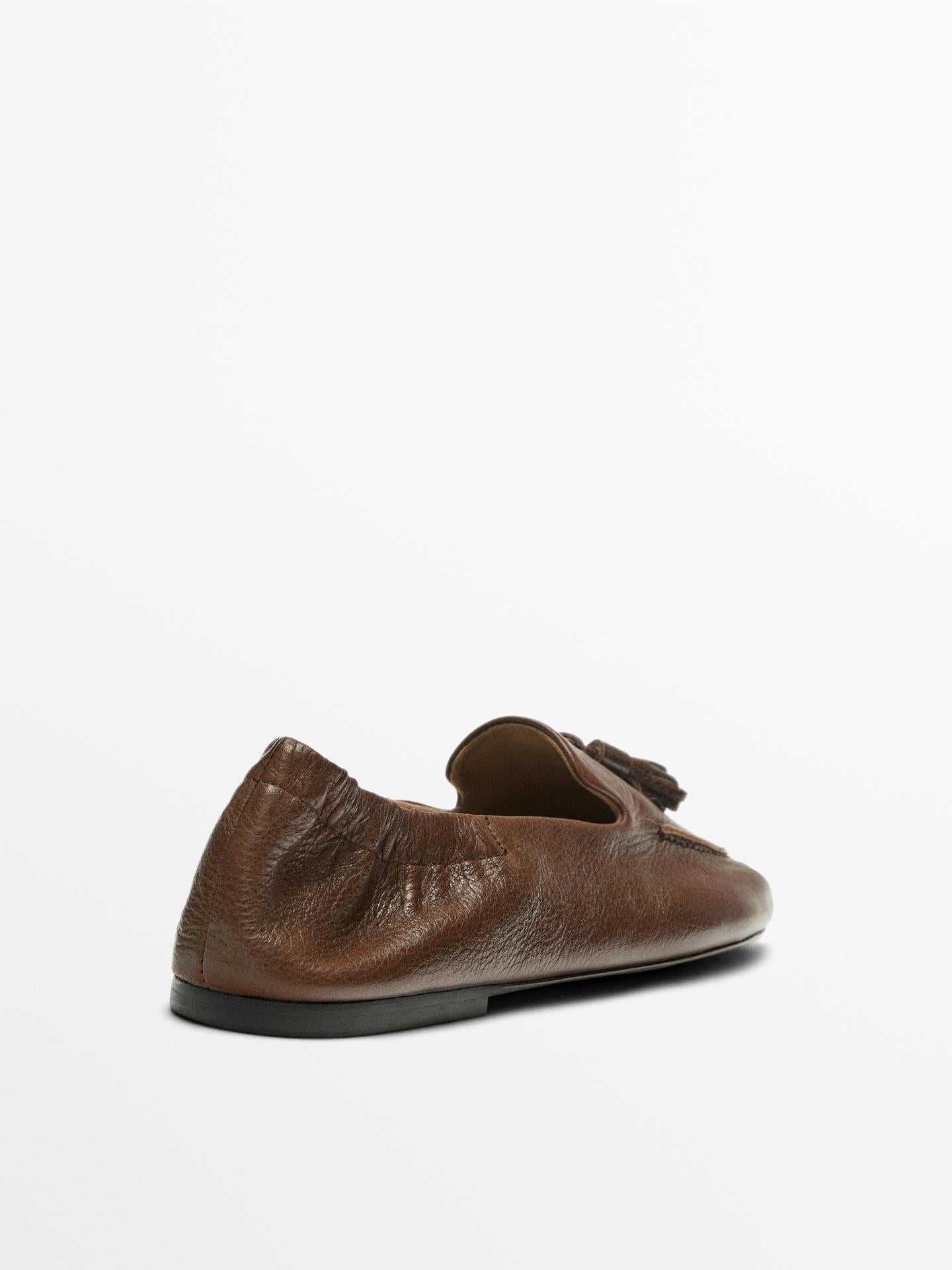 MOCASSINS EN CUIR À POMPONS